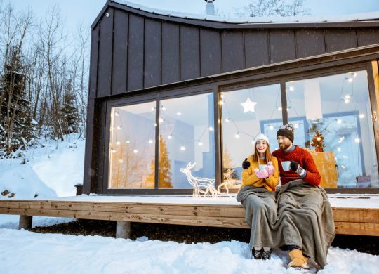 Couple réchauffe près de la maison pendant les vacances d’hiver