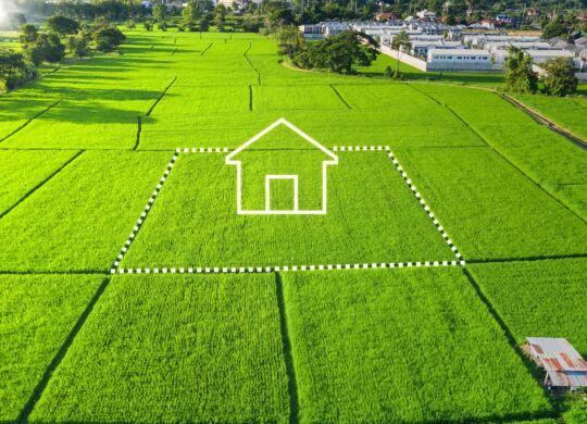 Icone de maison au milieu d'une vue aérienne de terrains pré découpés